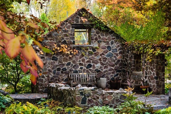 spring house ruin with fall colors in background